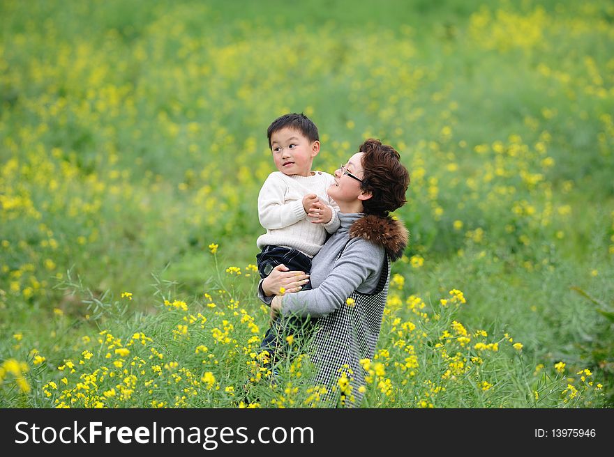 Mother and son outdoor in flowers. Mother and son outdoor in flowers.