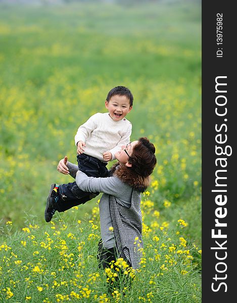 Mother and son outdoor in flowers. Mother and son outdoor in flowers.