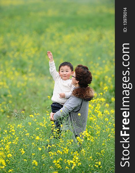 Mother and son outdoor in flowers. Mother and son outdoor in flowers.