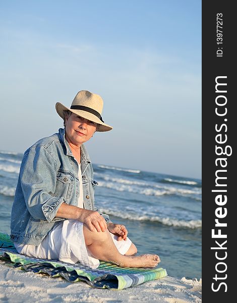 Mature Woman In Panama Hat At The Beach