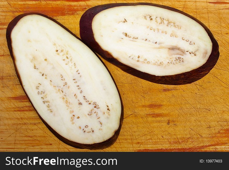 Purple egg plant aubergine on wooden board