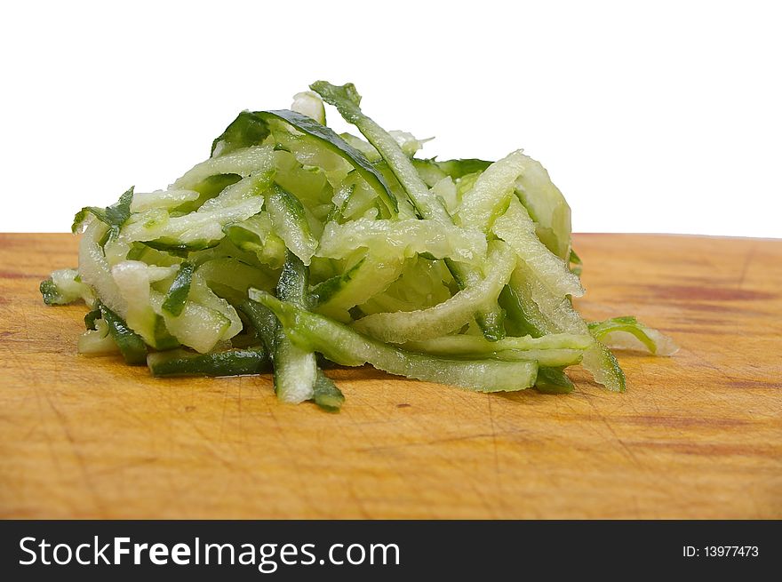 Green small cucumber  grated on wooden board