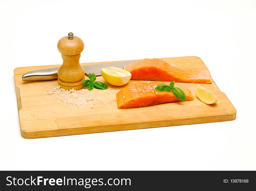 Raw salmon on chopping board isolated on white. Raw salmon on chopping board isolated on white