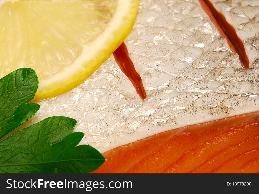 Macro of fresh salmon skin with lemon slice. Macro of fresh salmon skin with lemon slice