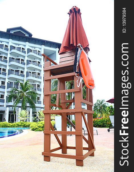 An image showing a lifeguard chair at a poolside of a luxury hotel. An image showing a lifeguard chair at a poolside of a luxury hotel