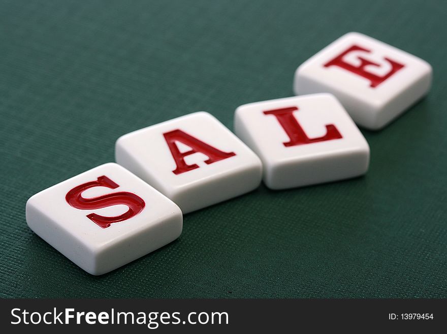 Letters on darkly green background make word Sale. Letters on darkly green background make word Sale.