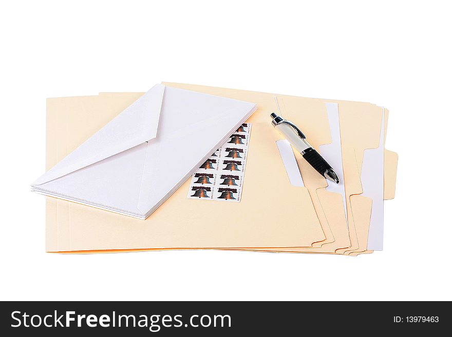 Office table with folders in which envelopes and documents and pen are enclosed.