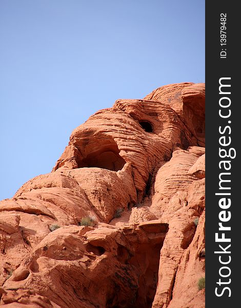 Mummy face on a red rock cliff wall in Valley of Fire