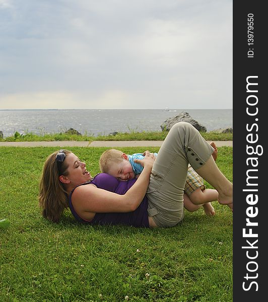 Mother and child playing on beach focus on child.