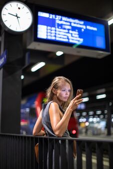 Pretty, Young Female Commuter Waiting For Her Daily Train Royalty Free Stock Photos