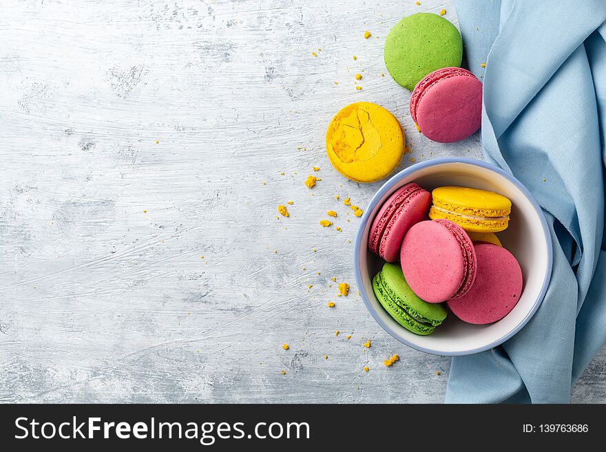 Colorful french macarons on concrete background. Top view. Copy space