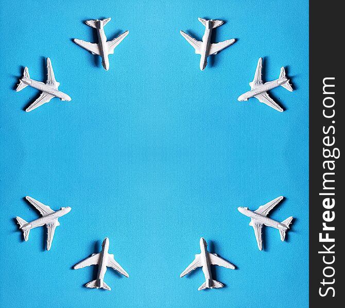 design of white plastic planes with blue background