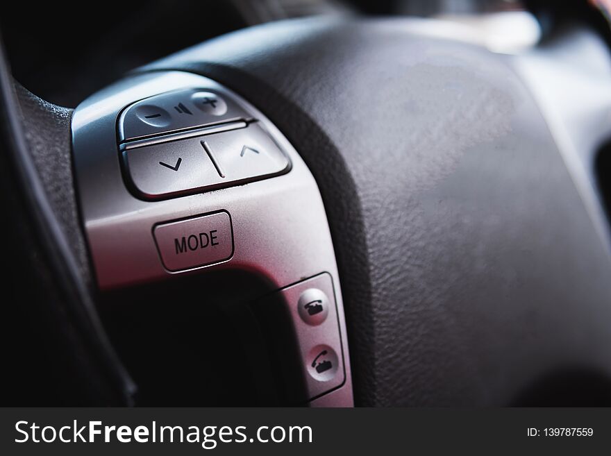 Close up steering wheel with control buttons close-up. Car stereo system control