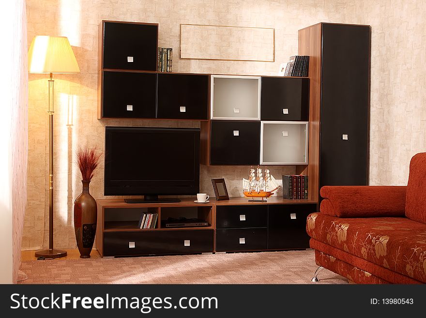 Interior of a living room with a window and different furniture