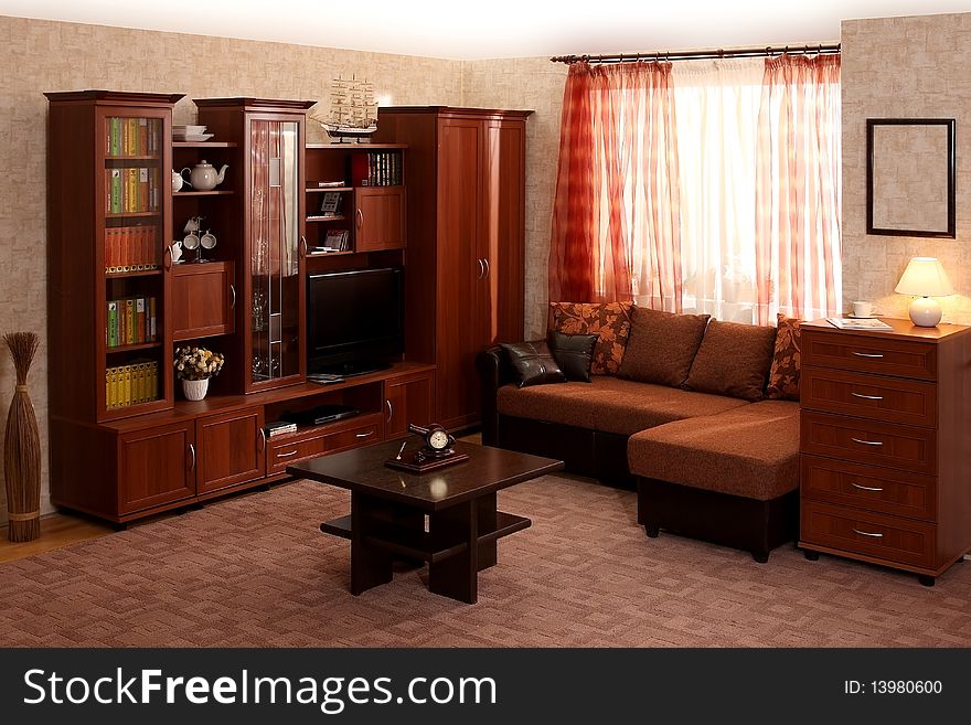 Interior of a living room with a window and different furniture