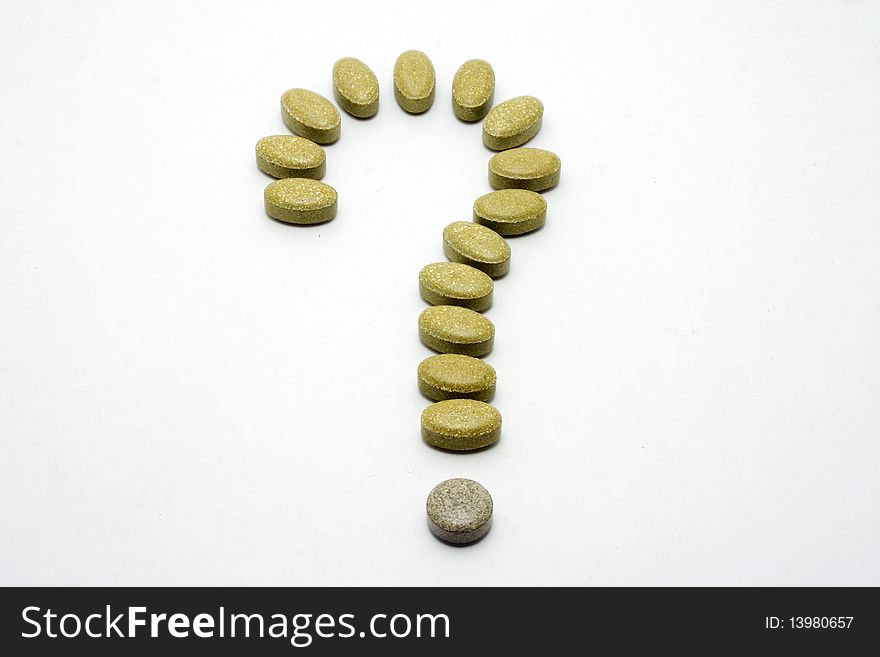 Medicine pills with question mark shape.