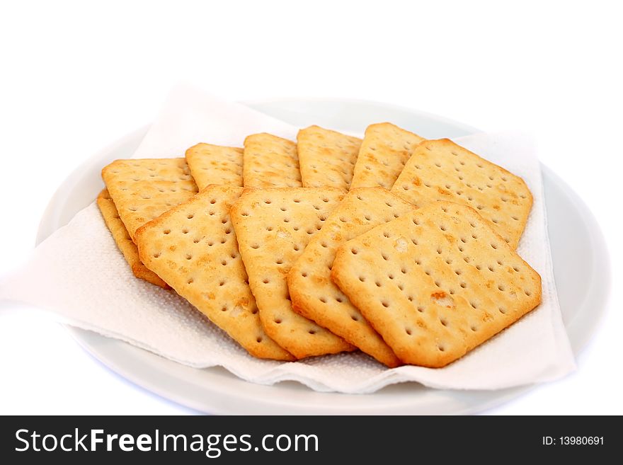 Crackers on plate isolated on white background.