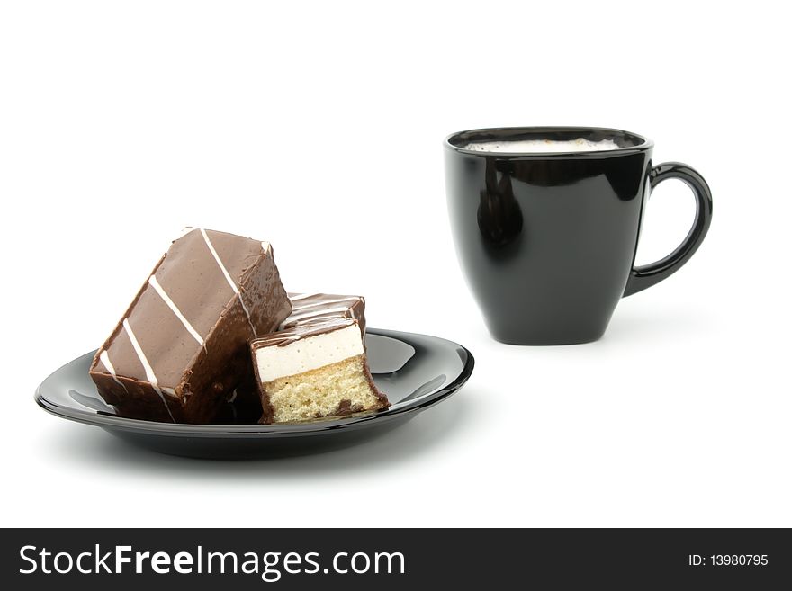 Three cookie in chocolate on black plate and cup of coffee isolated on white