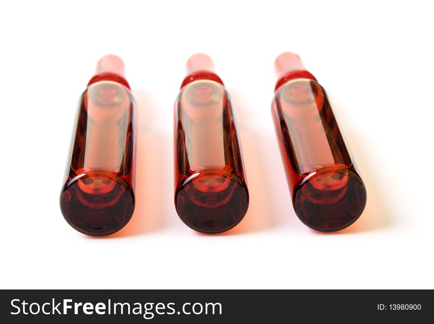 Red ampoules on a white background it is isolated