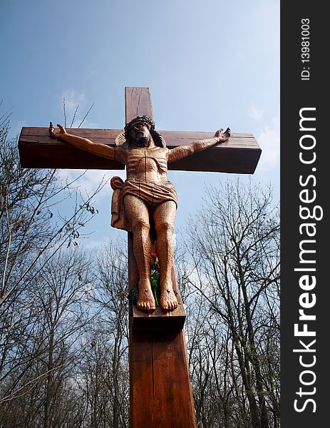 A wooden cross, a crucifix against the blue sky
