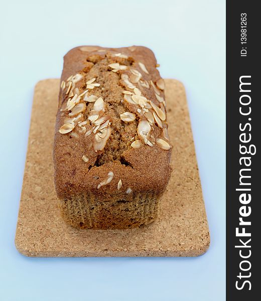 Almond orange cake isolated against a blue background