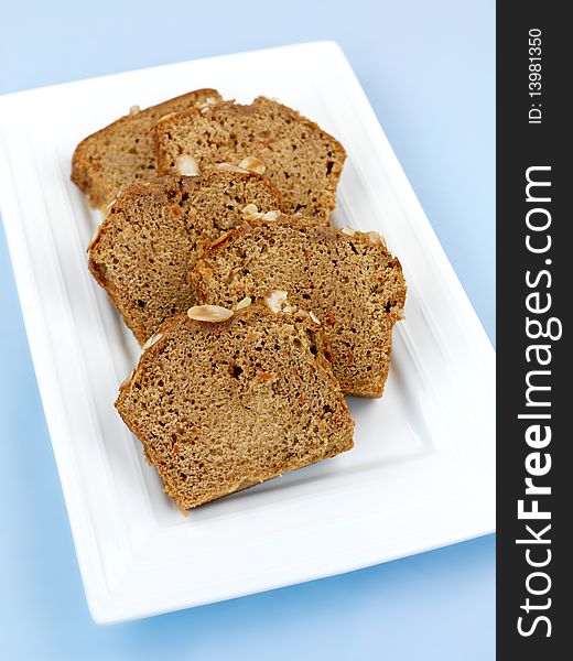 Almond orange cake isolated against a blue background