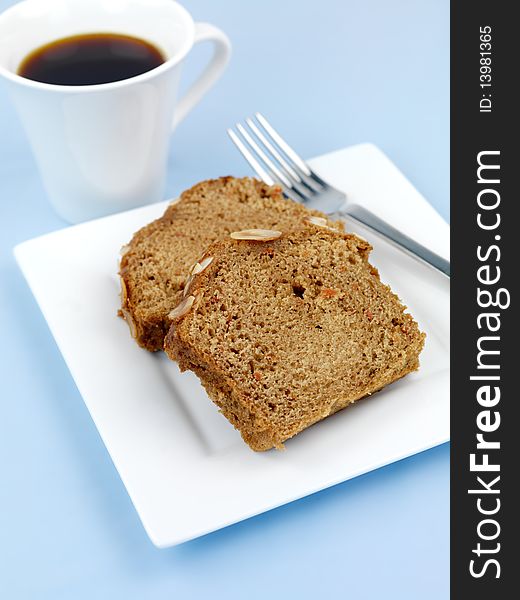 Almond orange cake isolated against a blue background