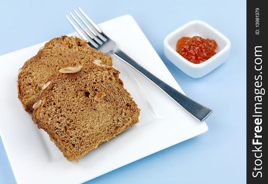 Almond orange cake isolated against a blue background