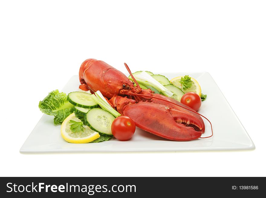 Whole cooked lobster with salad on a plate. Whole cooked lobster with salad on a plate