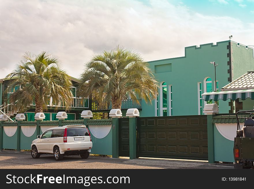 Modern suburban family houses with a garage gate and the car