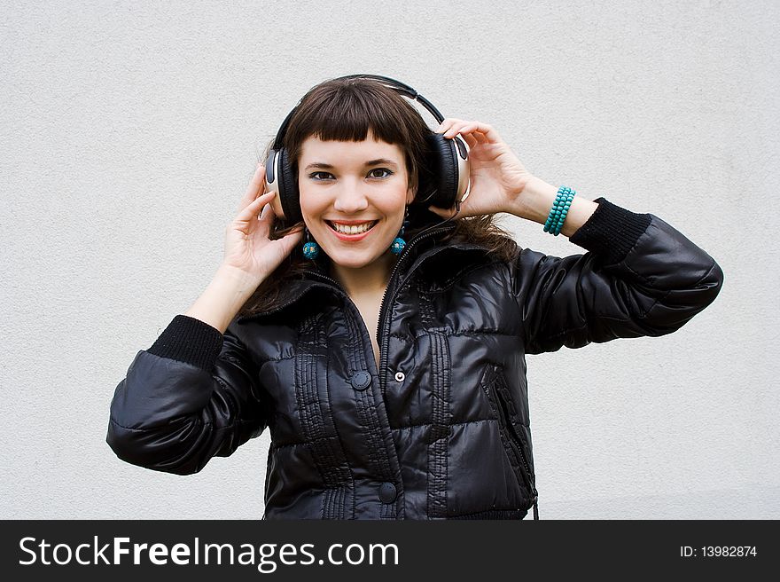 Beautiful girl listens a music, outdoor snapshot