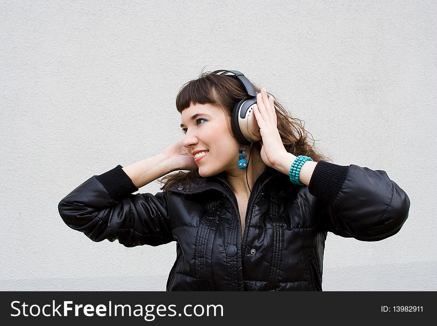 Beautiful girl listens a music, outdoor snapshot