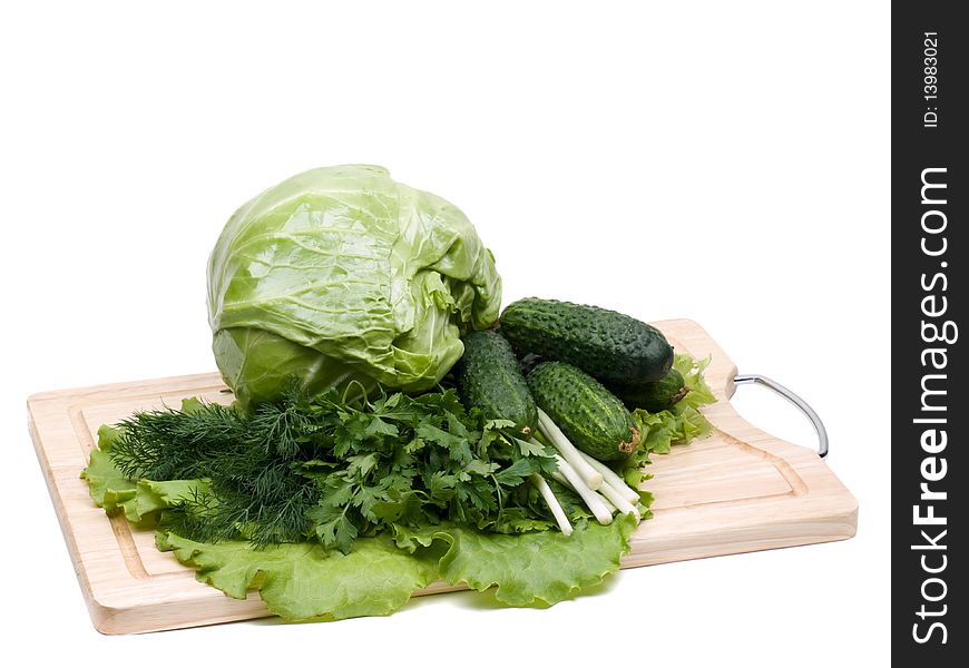 Fresh green-stuffs on cutting board on white background