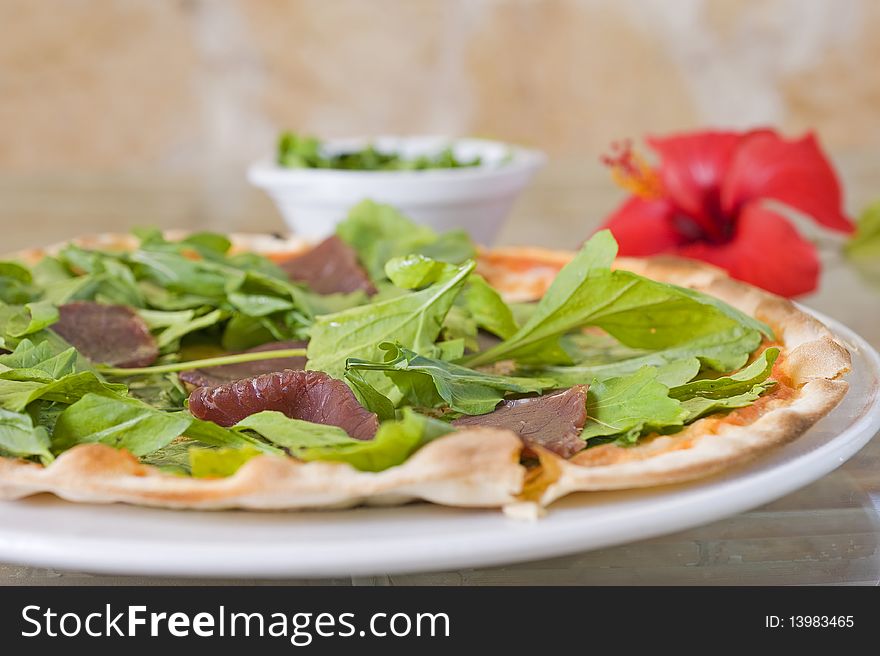 Beef pizza with salad topping