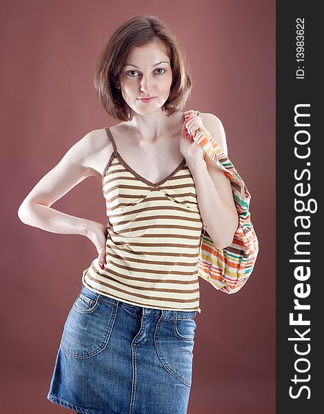 Sexy caucasian girl with colorful bag on brown background. Sexy caucasian girl with colorful bag on brown background