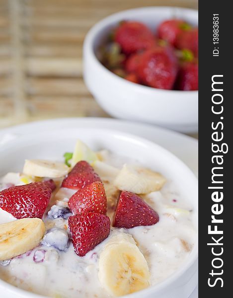 Fresh fruit salad in a bowl with strawberrues and bananas. Fresh fruit salad in a bowl with strawberrues and bananas