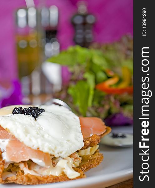 Gourmet smoked salmon burger with fried egg and caviar