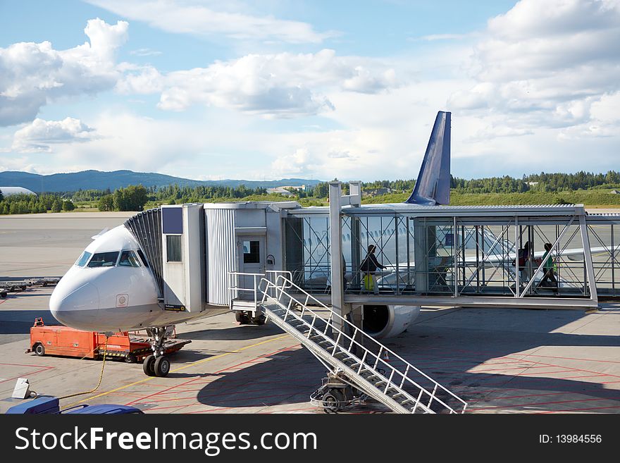 Airplane near a terminal with nature view background