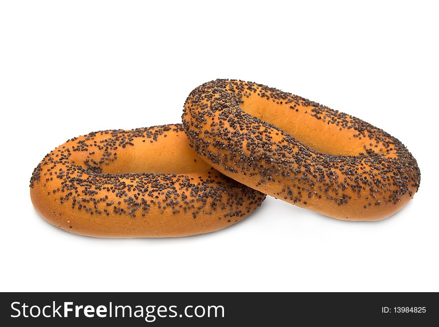 Two bagels with poppy seeds on white background