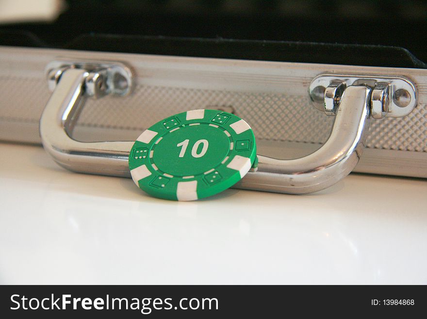 Focus on green casino chip with the value ten. Focus on green casino chip with the value ten