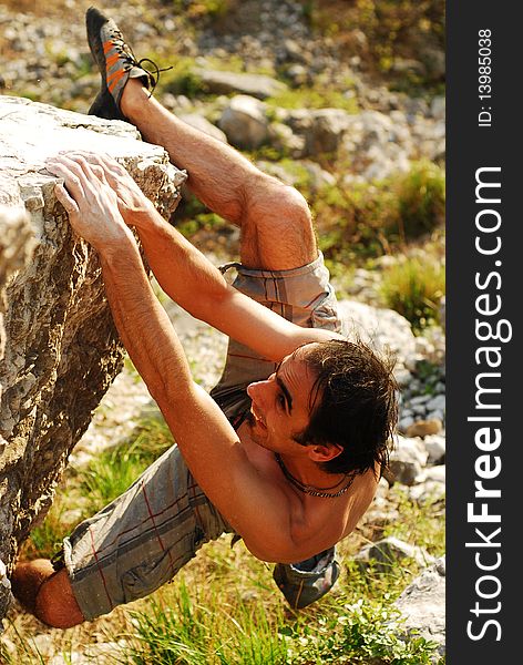 Male climber climbing a boulder