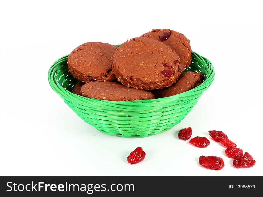 Homemade cakes with cranberries in a basket isolated on white