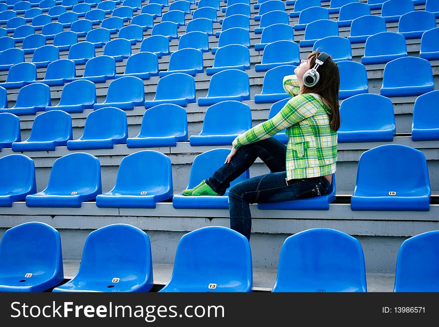 Teen at the stadium with earphones. Teen at the stadium with earphones