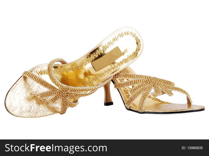 This is a beautiful ladies fashionable golden shoes isolated on a white background. This is a beautiful ladies fashionable golden shoes isolated on a white background.