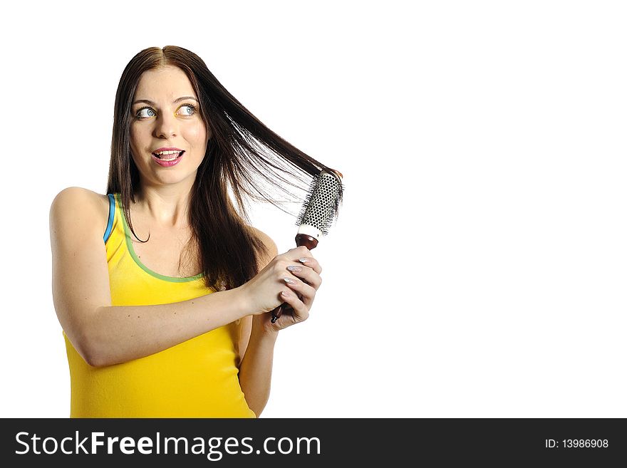 Young beautiful woman in yellow shirt brushing her healthy hair. white background. copy-space. Young beautiful woman in yellow shirt brushing her healthy hair. white background. copy-space