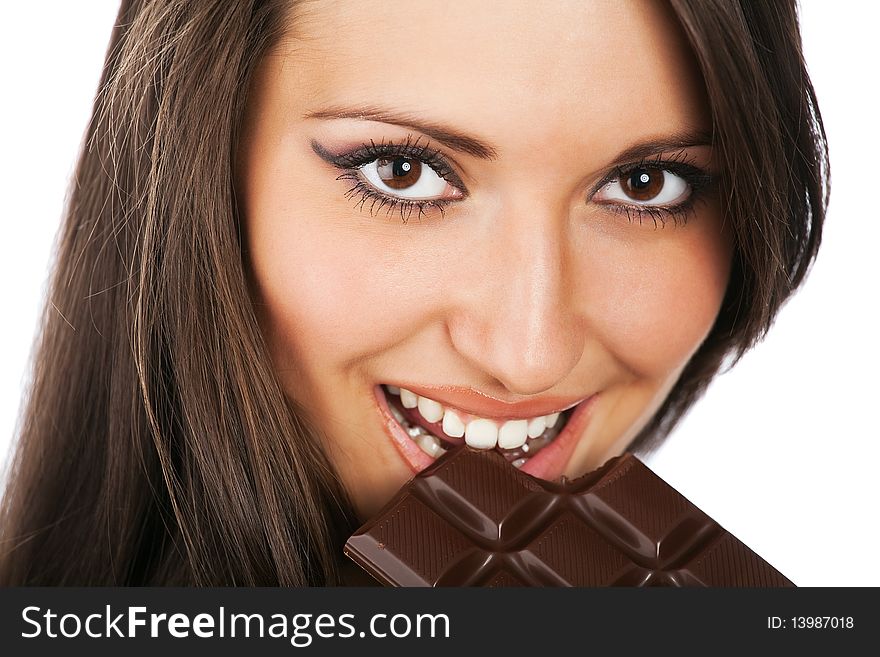 Portrait of young smiling woman eating chocolate