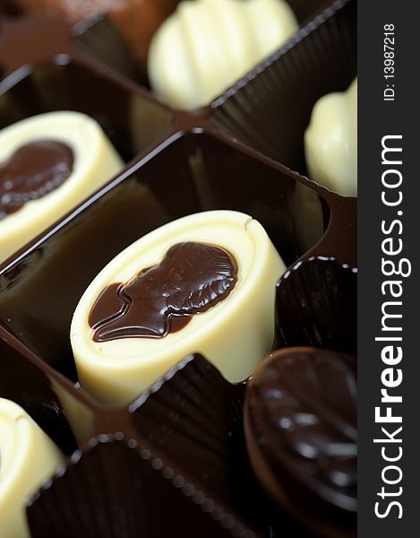Delicious background of swiss dark chocolates, milk chocolates, pralines and truffles