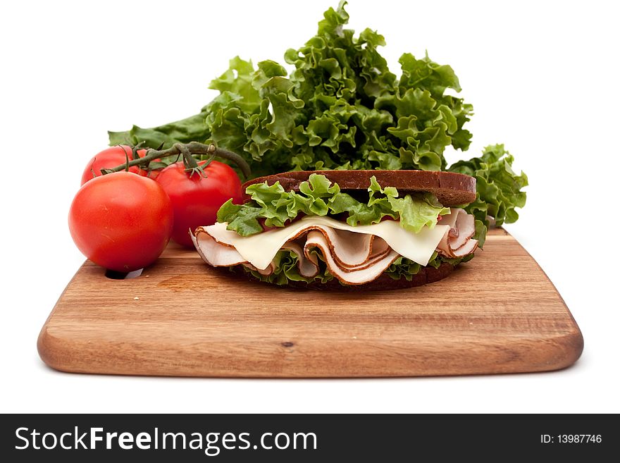 Healthy turkey breast sandwich on rye bread with vine ripe tomatoes and lettuce on white background. Healthy turkey breast sandwich on rye bread with vine ripe tomatoes and lettuce on white background