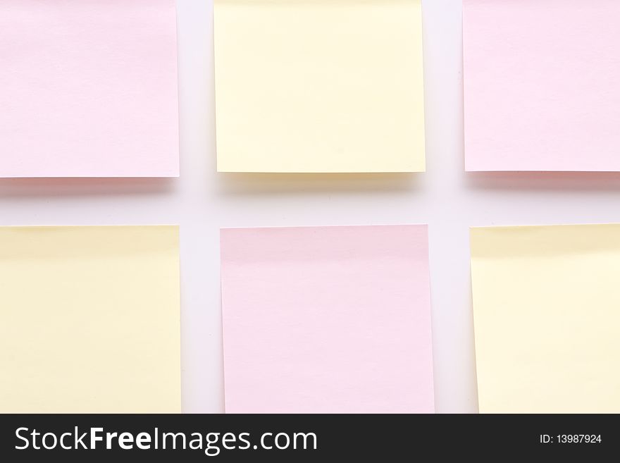 Blank yellow and pink post it notes