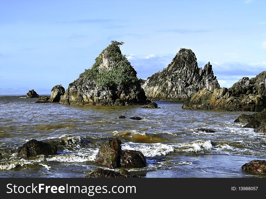 Rock at the edge of the tropical sea coast, north of Java, Indonesia.